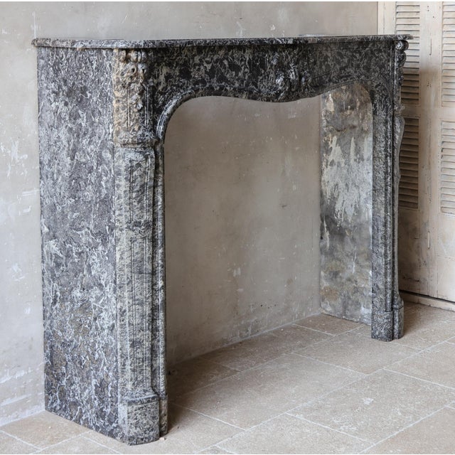 This impressive antique Dutch marble fireplace in the "Trois Coquilles" model is crafted from St. Anne marble. The front...