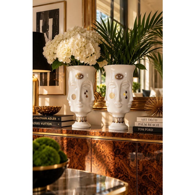Stunning pair of Jonathan Adler Gilded Dora Maar urn vases, crafted from glossy white porcelain with striking gold...