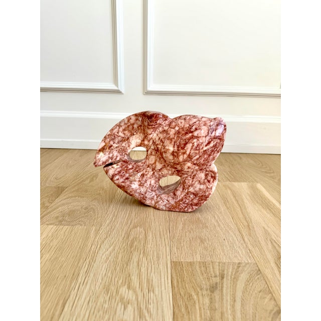 Mid-century modern fish form carved from Rosa Portogallo marble. The design features flowing, organic contours and pierced...