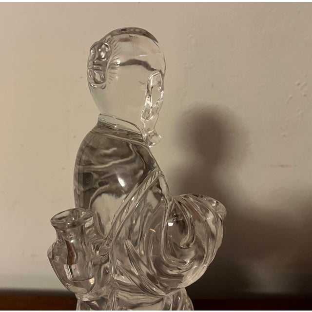 Antique Chinese carved rock crystal figure of an immortal. Mounted on a conforming wood and brass base. Formerly used as a...