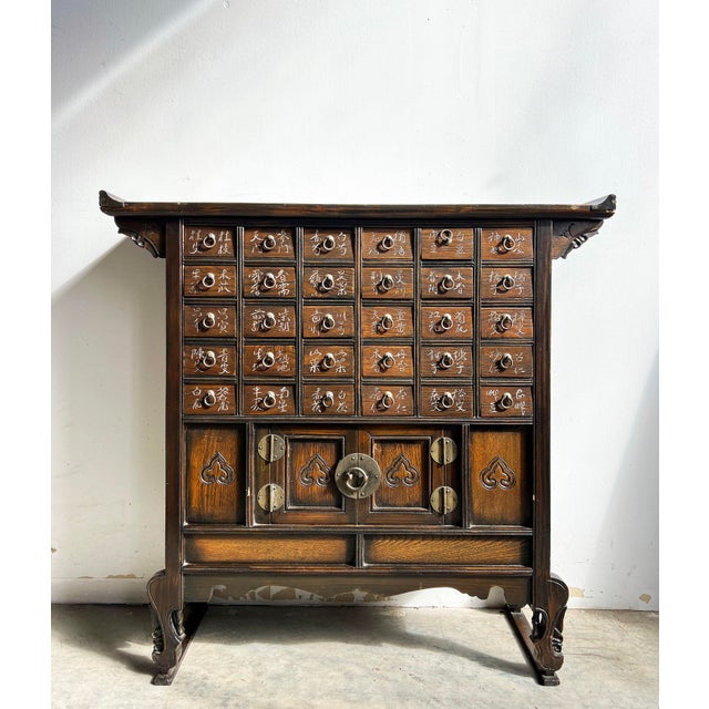 This beautifully crafted Korean apothecary chest, also known as a yakjang (약장) or medicinal cabinet, features multiple...