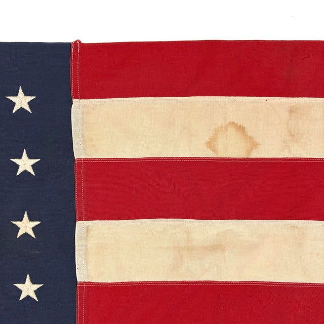 This large vintage American flag is made from a cotton cloth, with fully sewn stripes and 48 embroidered stars. Please...