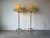 Striking pair of vintage hand-wrought iron floor lamps featuring a sculptural tripod base and slender stem, reminiscent of...