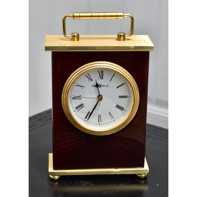 Vintage (1980's) Desk/Mantel Clock has a Traditional Style. Made by Howard Miller. Wood, Composite and Brass. Roman...