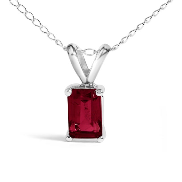 Draped in the regal splendor of a color-enhanced, natural ruby, this 14K white gold pendant necklace exudes elegance with...