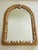 Mid century wicker wall mirror encrusted with sea shells as coastal decor.