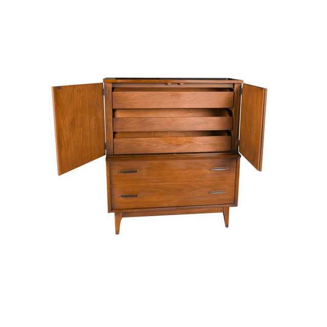 A classic Mid Century Modern walnut tallboy dresser with burled walnut center doors by a division of Broyhill, “Lenoir...