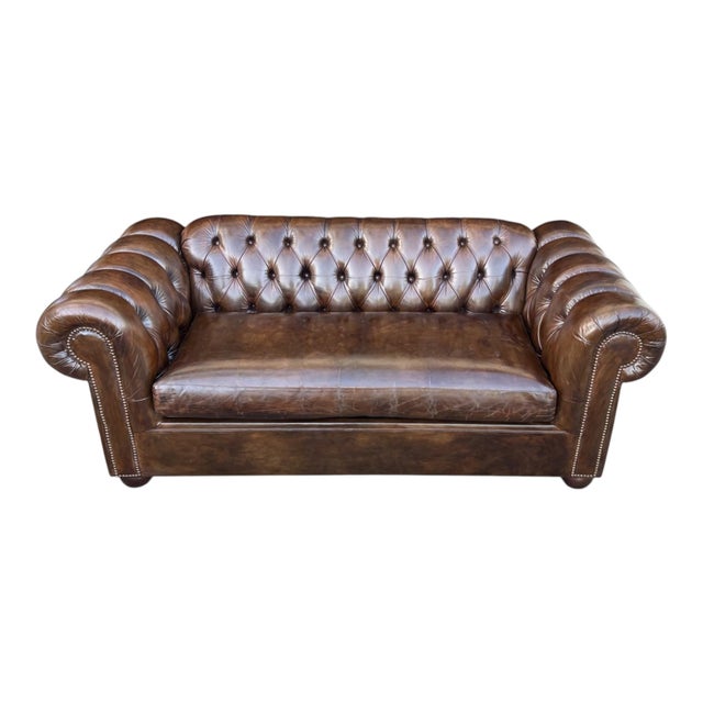 This beautifully restored vintage Chesterfield leather sofa showcases timeless English design with its deep button-tufted...