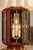 A striking matched pair of oversized lantern-form table lamps, combining warm reddish-brown wood, bright brass detailing,...