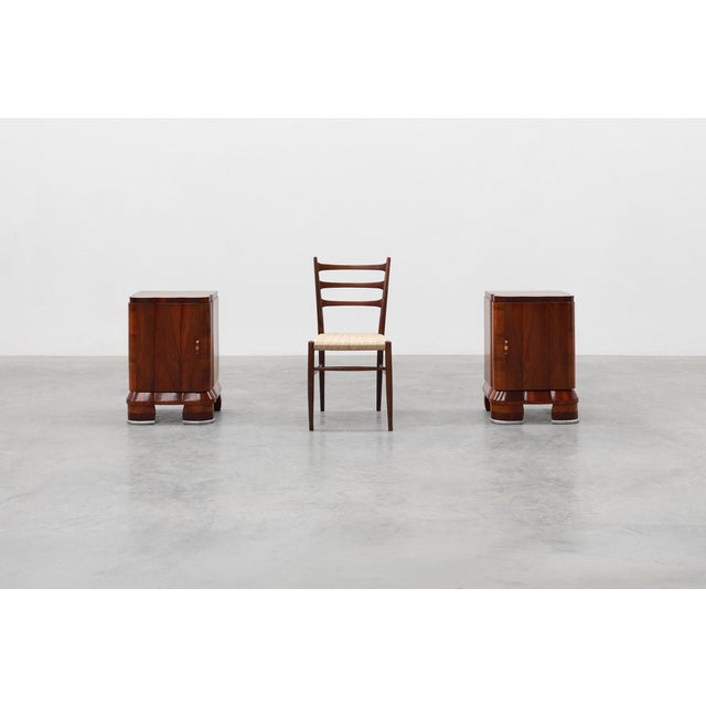 A sophisticated pair of Italian Art Deco nightstands from the 1920s, crafted in beautifully figured walnut and...