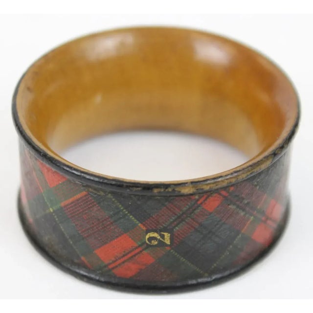 This is an antique tartanware napkin ring. The piece dates back to the early 20th century.