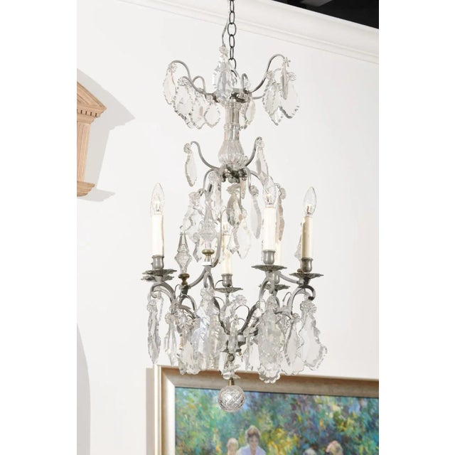 A French six-light crystal chandelier from the 19th century, with silvered iron armature. Born in France during the 19th...