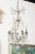 A French six-light crystal chandelier from the 19th century, with silvered iron armature. Born in France during the 19th...