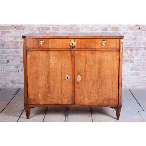 This architecturally clean, shape-balanced, and historically valuable Empire-style cabinet dates from the 1810s in...