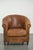 This well-loved sheepskin club chair has a beautiful vintage patina and a comfortable seat. There are a few small tears on...
