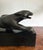 Vintage Art Deco revival black panther sculpture crafted in a dramatic elongated feline form and mounted upon a...