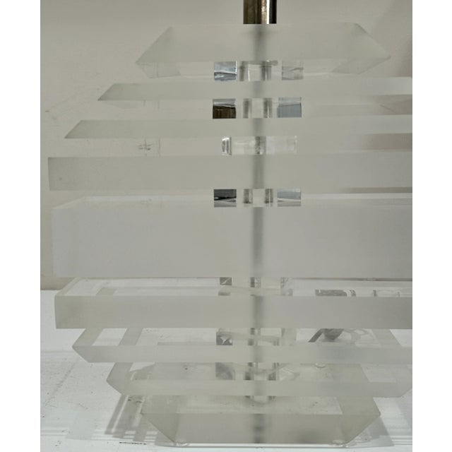 Lucite/Acrylic Lamp in the Style of Karl Springer This stacked geometric lamp, made of clear lucite/acrylic, reflects the...