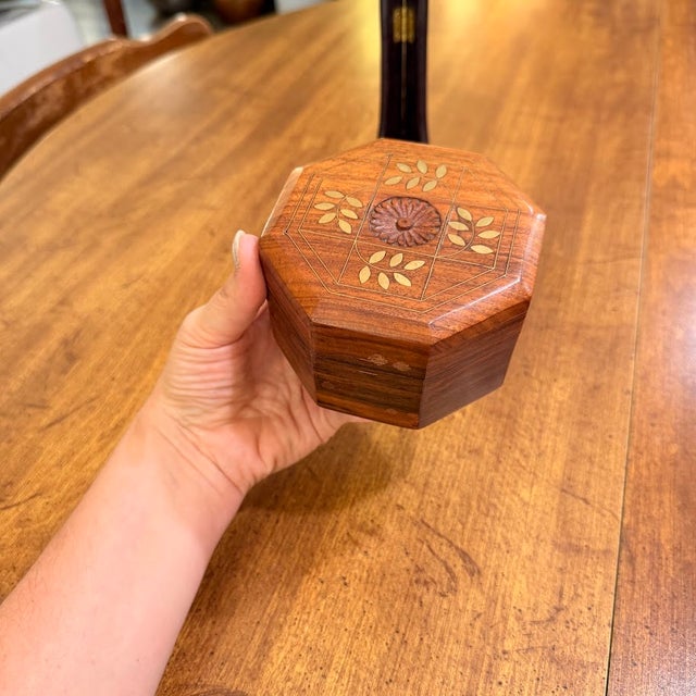 Handcrafted octagonal wooden trinket box by Archana Crafts, made in India. This decorative piece features a rich, natural...