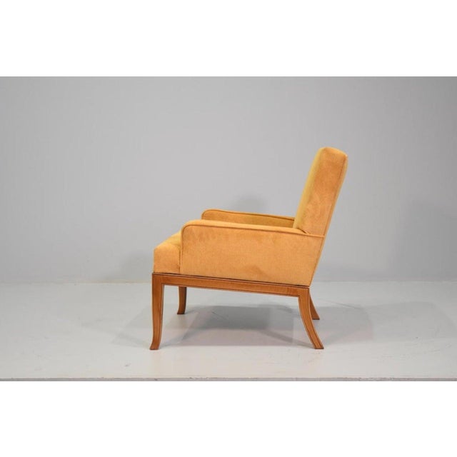 Two elegant lounge chairs, a classic example of T. H. Robsjohn-Gibbings design from the 1950s. The newly padded cushions...