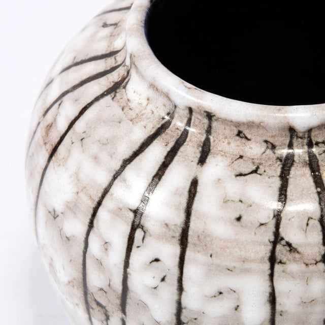 This Mid-Century Modernist Ceramic vase W/ Bowed Line Work is a beautiful example of Post War European Ceramics, realized...