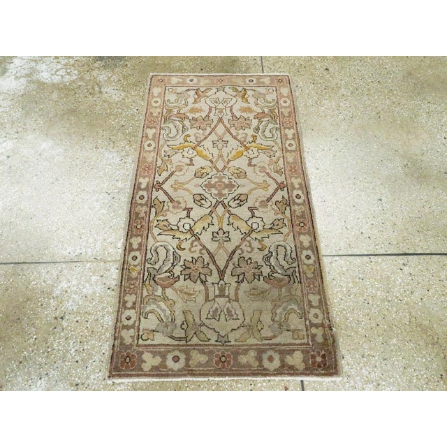 An antique Indian Lahore throw rug. The design looks like a part of a larger, repeating composition. An open lozenge...