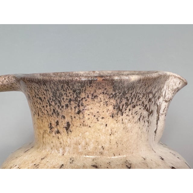 This handcrafted jug by the German ceramicist Richard Uhlemeyer (1900-1954) features a natural, almost stone-like glaze, a...