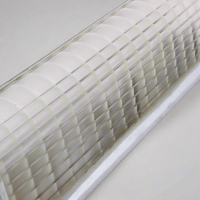 A single Art Deco period wall sconce of polished chrome and cast ribbed glass. The design features a tall vertical stepped...