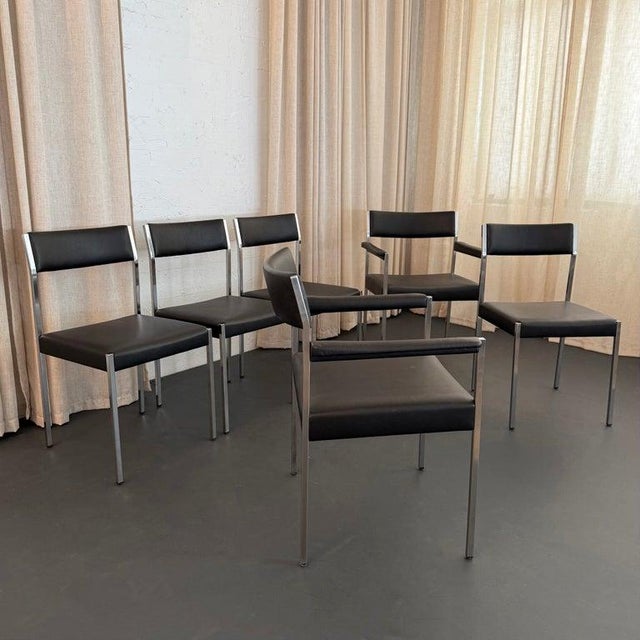 Elevate your dining space with this exceptional set of six mid-century minimalist dining chairs, designed in 1965 by Ernst...