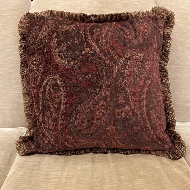 Pair available. Paisley design 24” square feather and down filled pillow with fringed trim. Rust or Burnt Red colored...