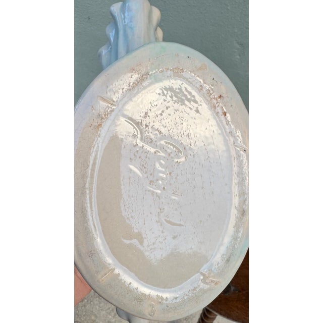 A shell, but make her pearlescent. This vintage ceramic shell vase / planter has the prettiest sculptural fan shape,...