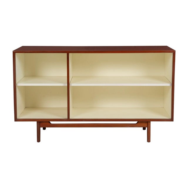 Jens Risom Open Book Cabinet, 1950c. Walnut case with white lacquered open shelving. Features divided, adjustable, and...