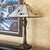 Handsome KL Tiffany-style Mission table lamp, featuring a sculptural bronze-tone metal base with flowing botanical and...