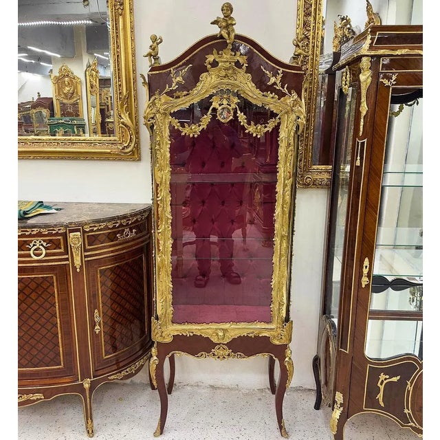 Stunning Red Wine French vitrine. Has been refinished in Italy. Has a beautiful gold details in the door. This piece is in...