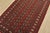 A tribal Bokhara rug hand-knotted with fine wool on a cotton foundation. This rug features rows of repeating medallions...