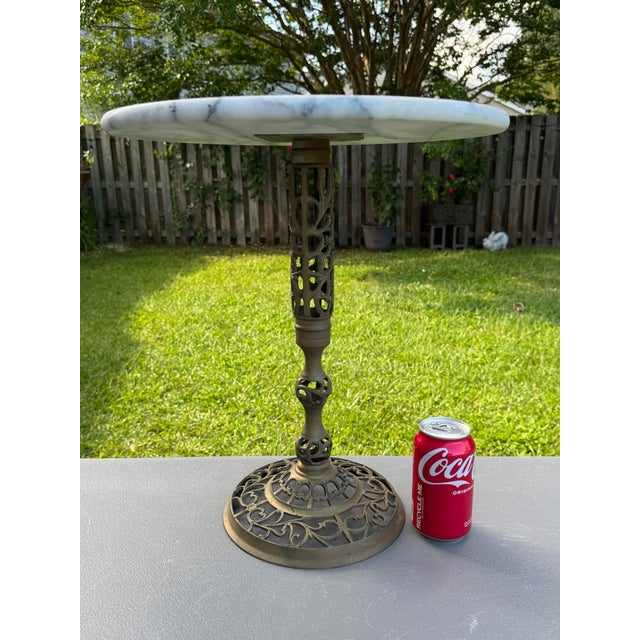 Offering for sale this exceptional vintage pedestal table featuring a white Italian marble top with gray veining and an...