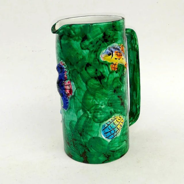 ceramic jug with decorative elements to Marini in relief and polychrome enamel, signed and Vietri Scotto