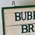 1930s Joyful Double Sided Wooden Trade Sign Advertising "Bubbling Brook Farm" in Green Paint For Sale - Image 4 of 10