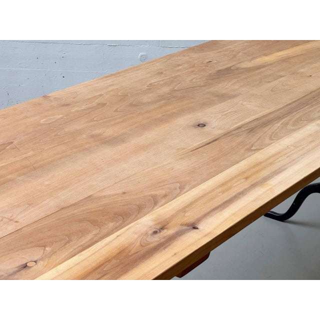 A characterful dining table with an original horgenglarus cast iron base, featuring classically curved legs. The black-...