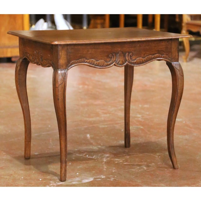 This elegant antique side table combines the warmth of richly patinated oak with the graceful lines of the Louis XV style....