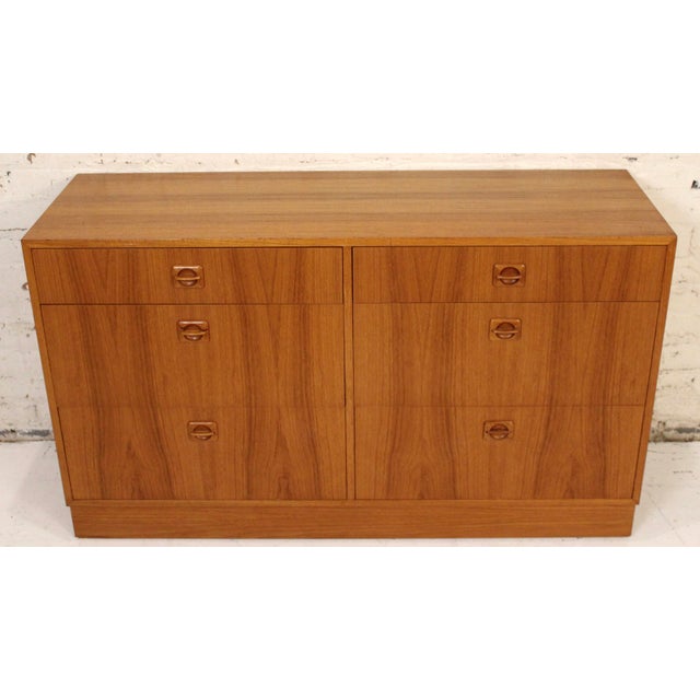 This stylish petite bedroom dresser features Scandinavian modern design, carved wood handles, and spacious interior...