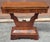 A 19th-century American Empire mahogany game or card table, featuring a serpentine flip-top and a harp-shaped base. Style:...
