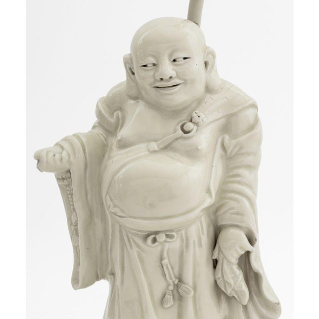 Chinese Blanc de Chine Buddha Sculpture Mounted as a Lamp, atop rockwork carved giltwood base. Overall: 17.5" H x 8" W x...
