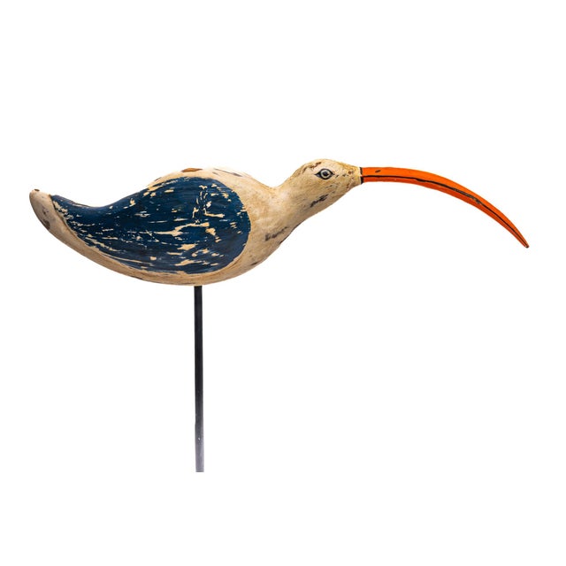 A classic American folk art shorebird distinguished by its bold painted wing and long, arcing beak. The contrast between...