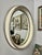 This French and Italian influenced oval wall mirror features a heavily molded, deep profile wood frame with distressed...