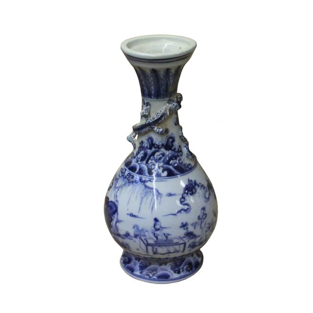 This is a Chinese decorative porcelain vase in Blue and White color finish. The theme is oriental house yard graphic....