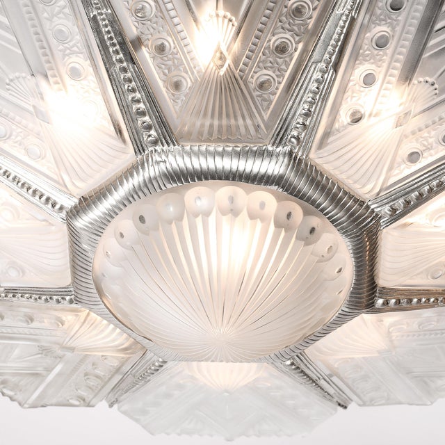 This exquisite Art Deco frosted glass pendant chandelier, signed by Jules Leleu and crafted in France circa 1930,...