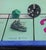Game On by Irene Georgopoulou | Pastel on paper depicting Monopoly game pieces and a dice. For Sale