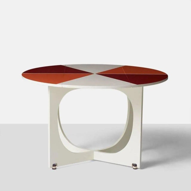 A very rare circular drop-leaf “Apta” table designed by Gio Ponti, circa 1970. The table top swivels for the leaves to...