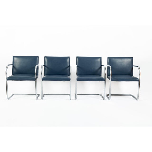 This set of four mid century modern Brno arm chairs designed by Ludwig Mies van der Rohe for Knoll was produced in 2013....