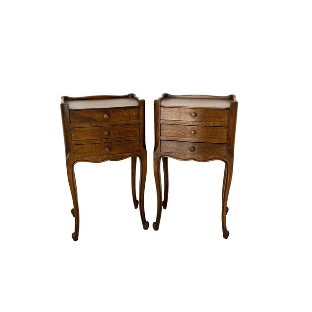 French side cabinets nightstand of 1970s. Massive oak and louis XV style. Each nightstand has three drawers. Good condition.